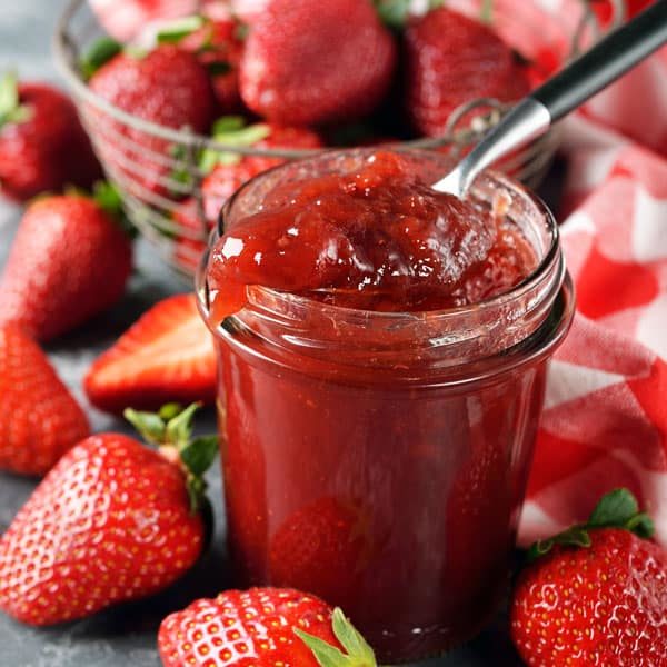 jar of strawberry jam and strawberries
