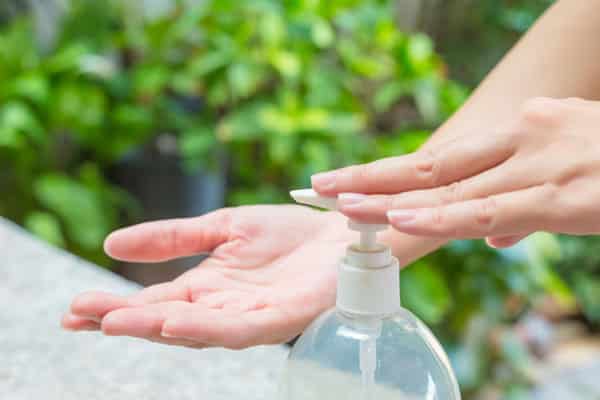 hand pumping sanitizer onto open hand