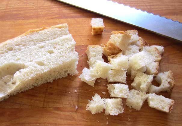 bread being cut into cubes