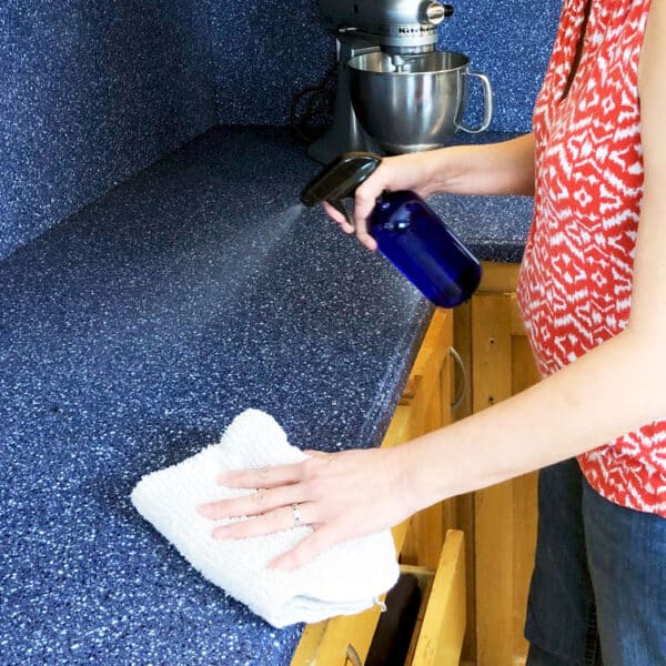 woman spraying counter