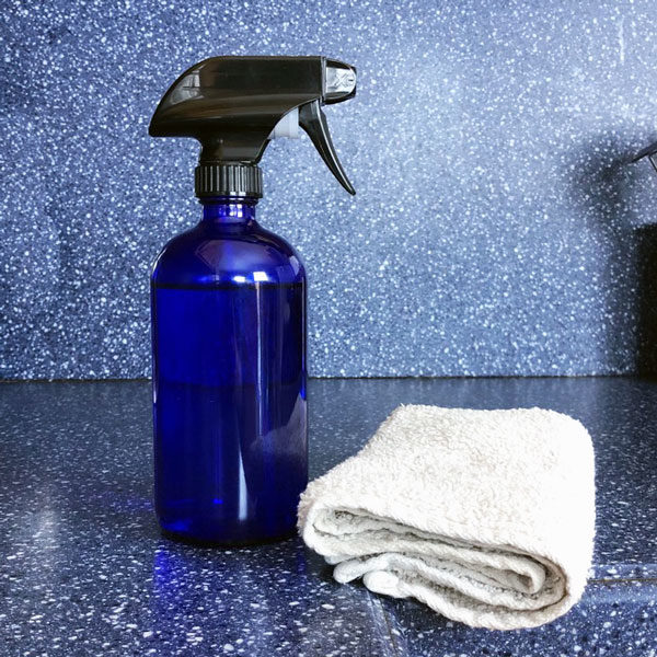 blue glass jar and white cloth on blue counter