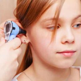 girl having ear examined with otoscope