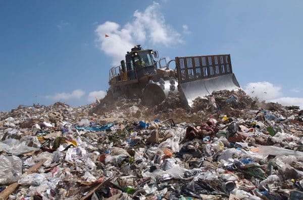 bulldozer on pile of garbage