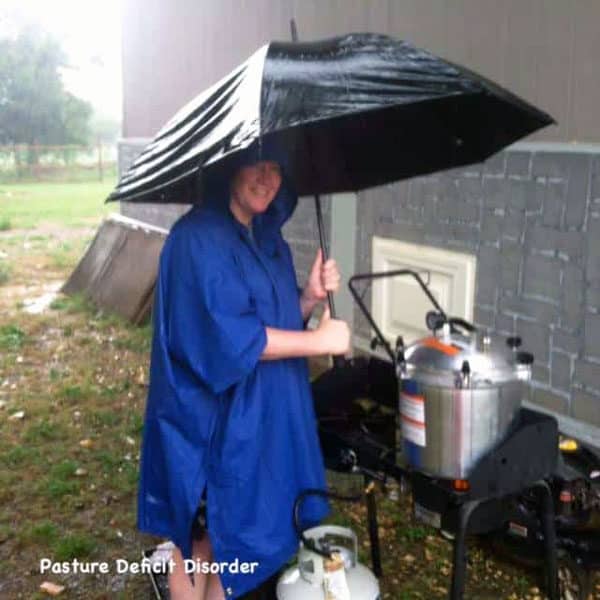 woman cooking outside in the rain