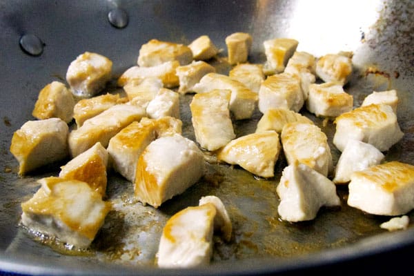 frying chicken bites in pan