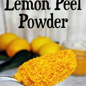 scoop of lemon peel powder in front of lemons
