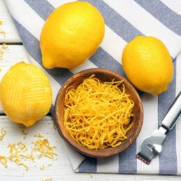 lemons and a bowl of lemon peel on a table