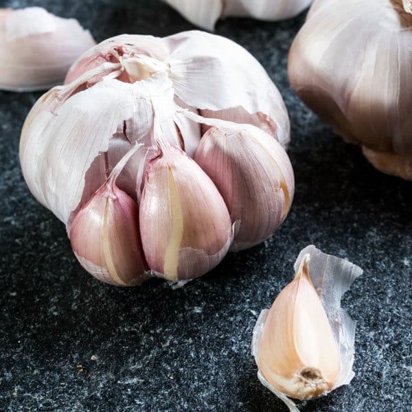 head of garlic on black counter