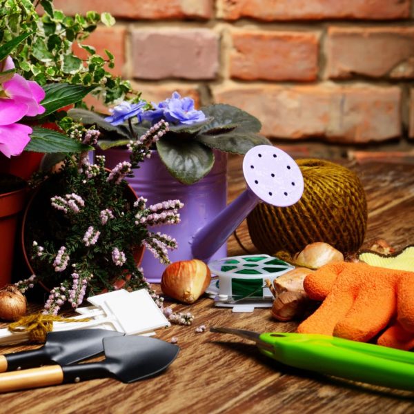 Gardening tools in front of brick