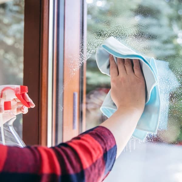 woman cleaning window