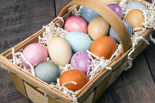 colorful naturally dyed easter eggs in wicker basket