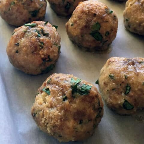 cooked meatballs on cookie sheet