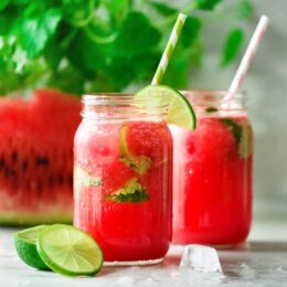 watermelon lime slushie in jar with straw