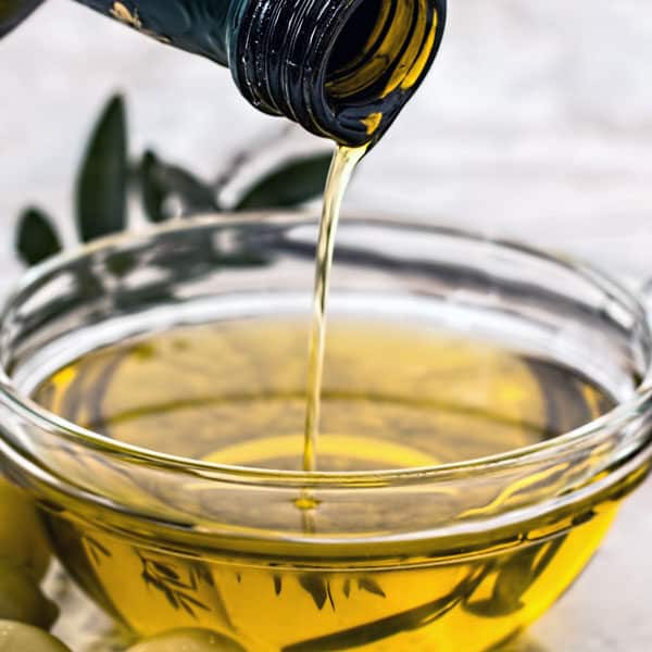 olive oil pouring into bowl