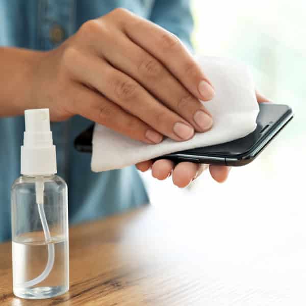 woman wiping smartphone screen with cloth