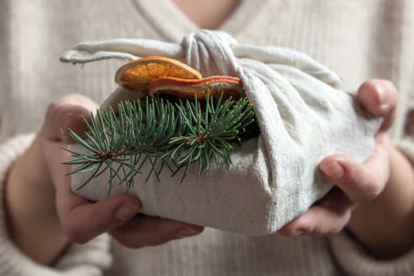 woman holding gift wrapped in fabric