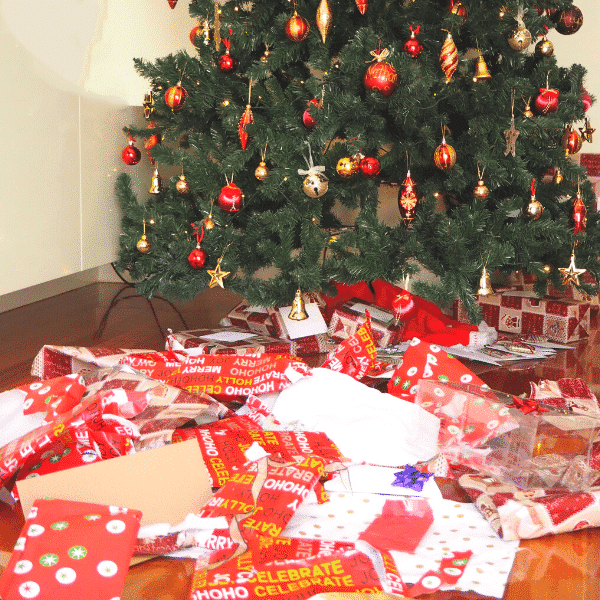 wrapping paper mess under Christmas tree