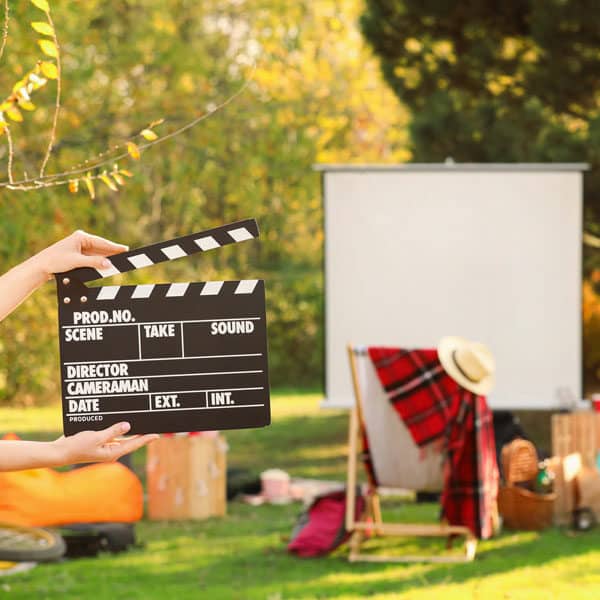 movie clapper and screen in garden