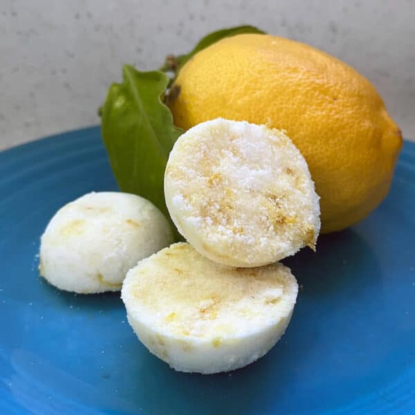 lemon and homemade garbage disposal cleaner tablets on a blue plate