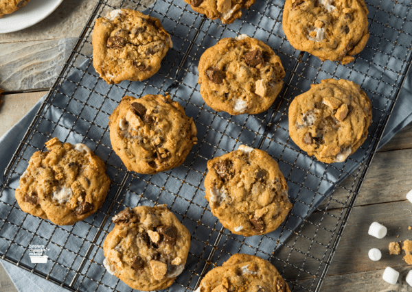 s'mores cookies on a wire rack over a blue placemat